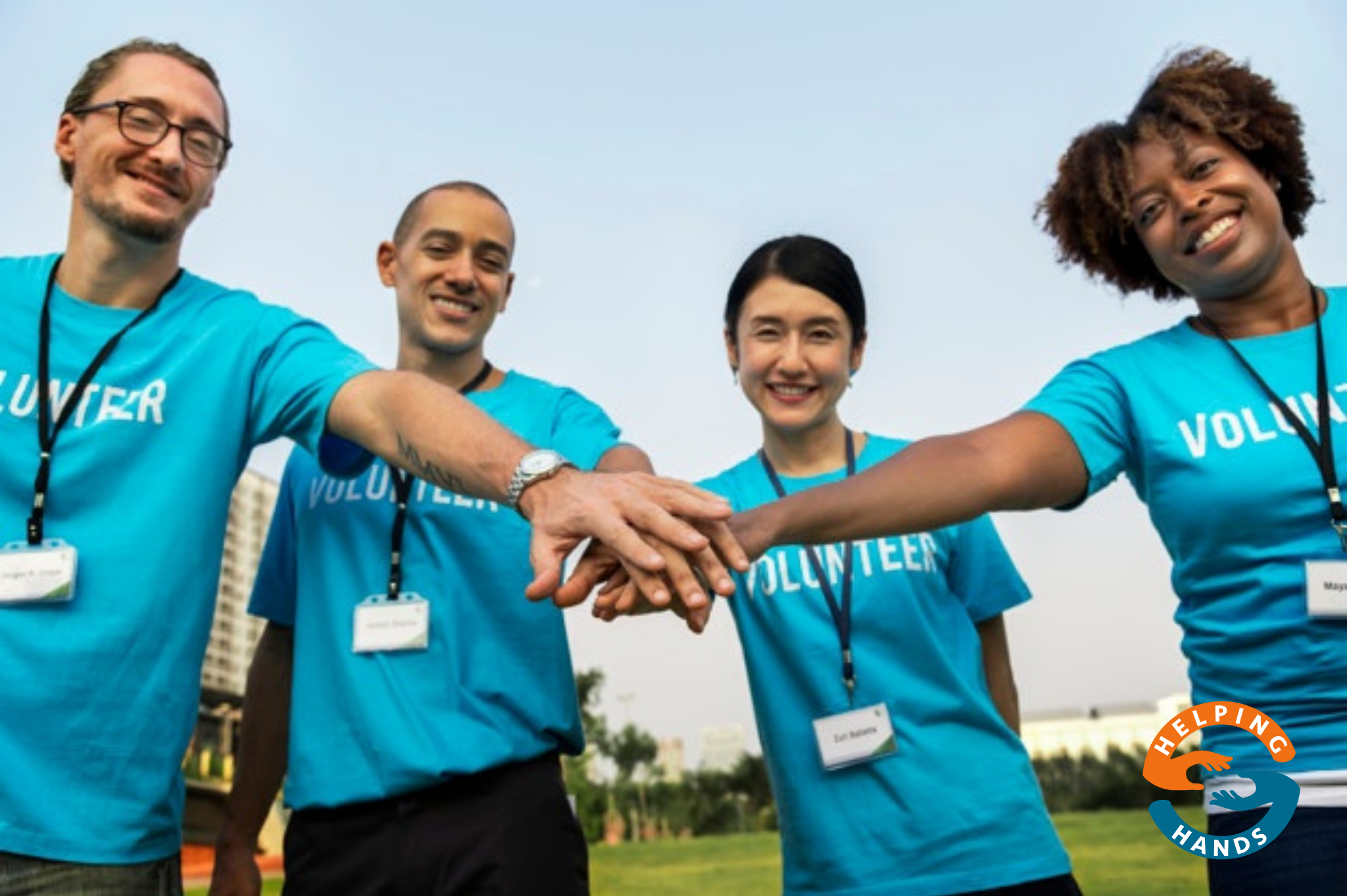 team of volunteers stacking hands